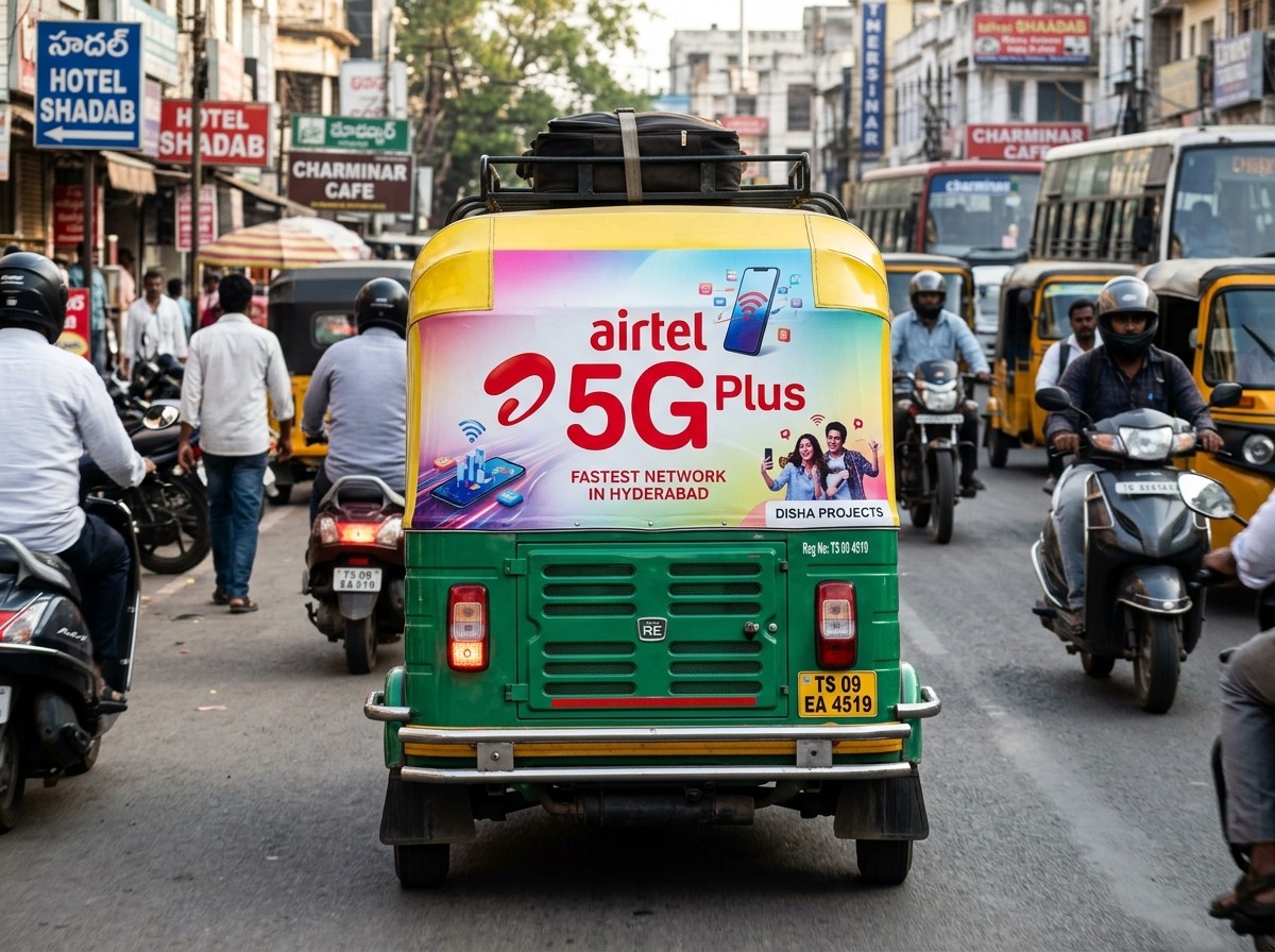 Auto-rickshaw advertising panel on a Hyderabad auto in daylight traffic